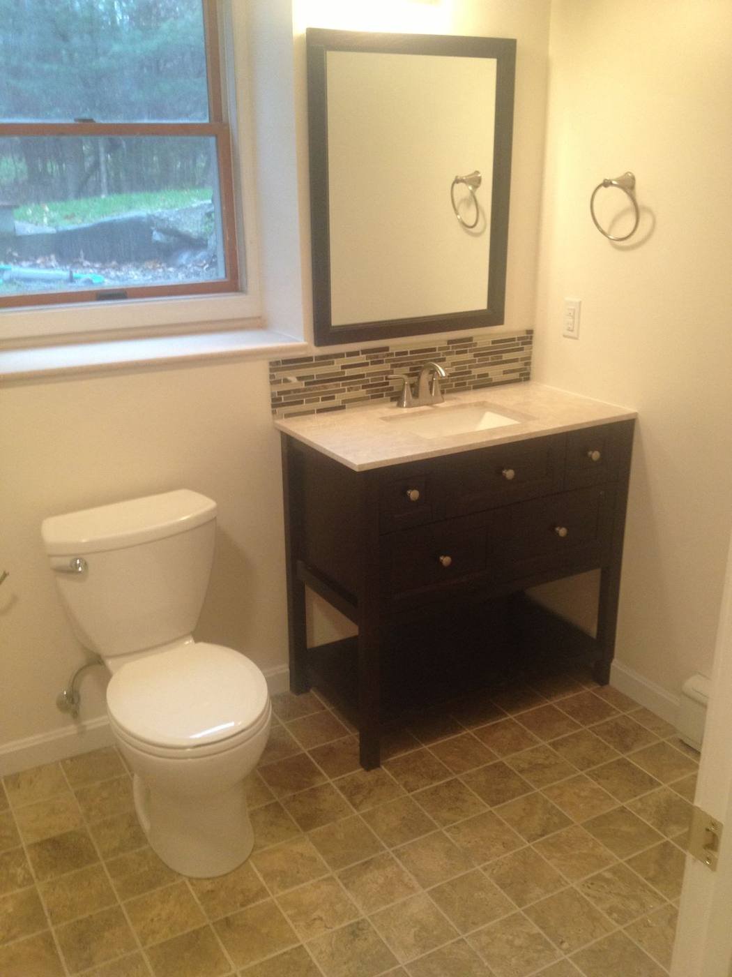 Basement bathroom with vanity and tile floor