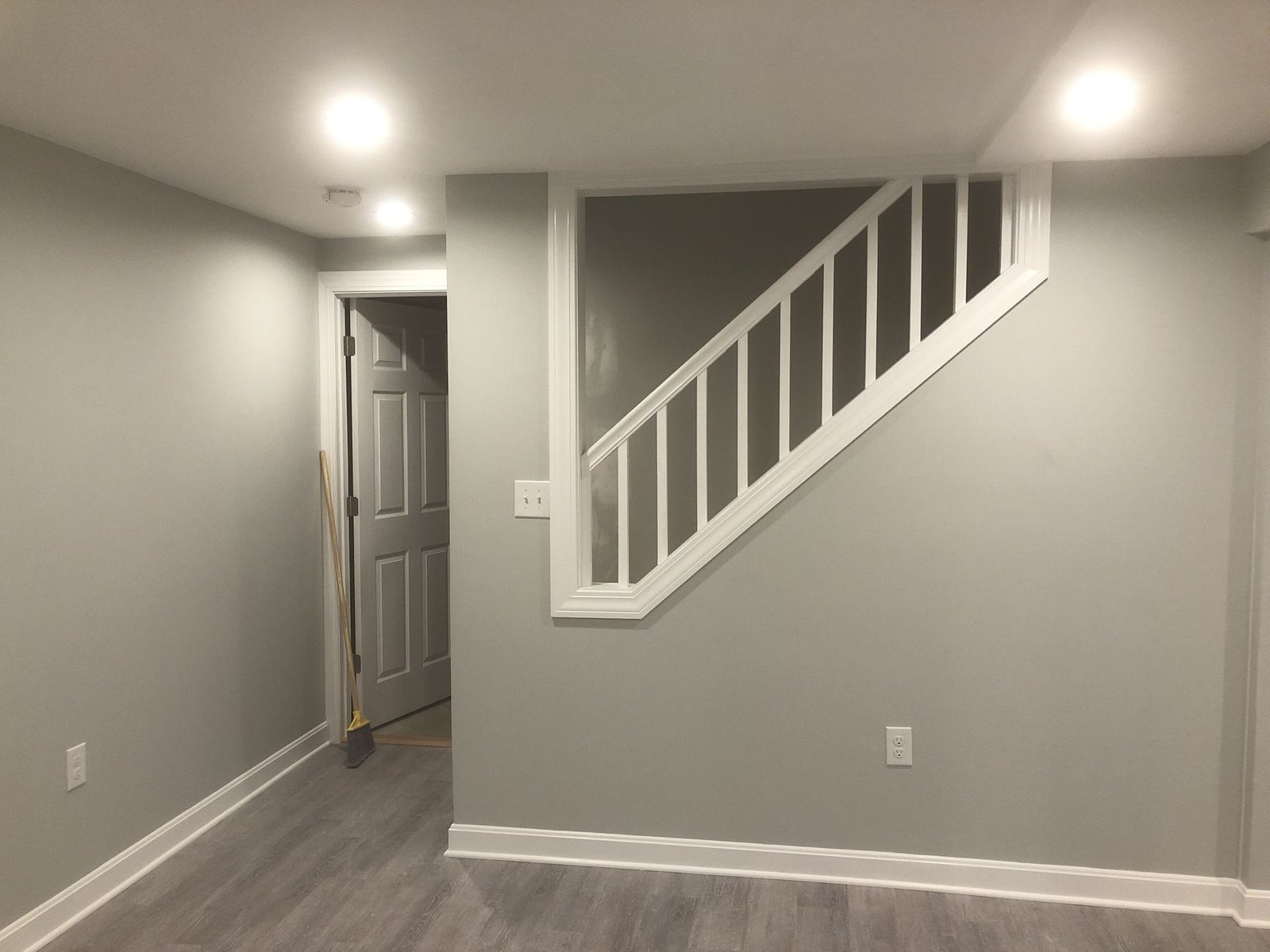 Finished basement with stairs and railing