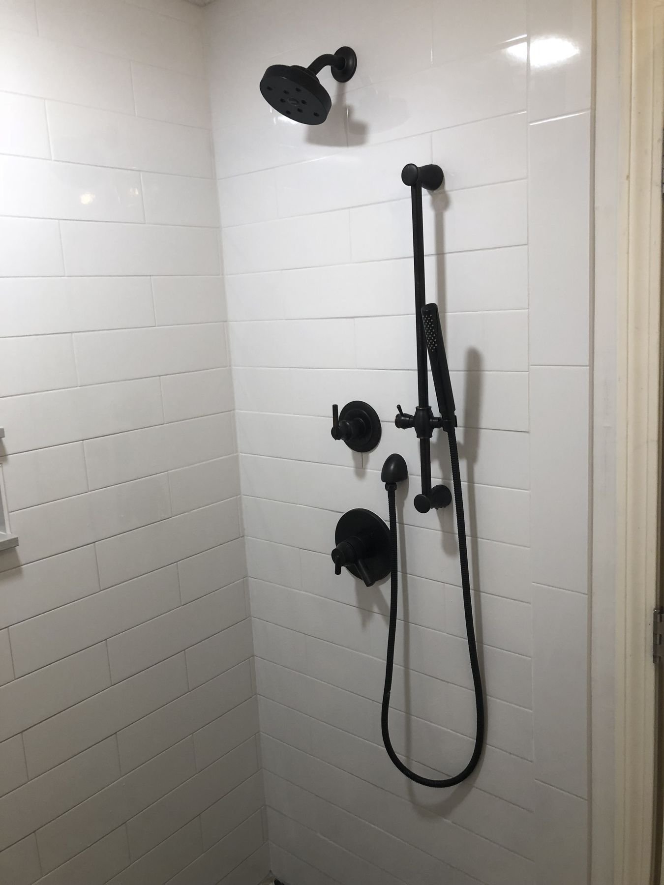 Tiled shower with black fixtures