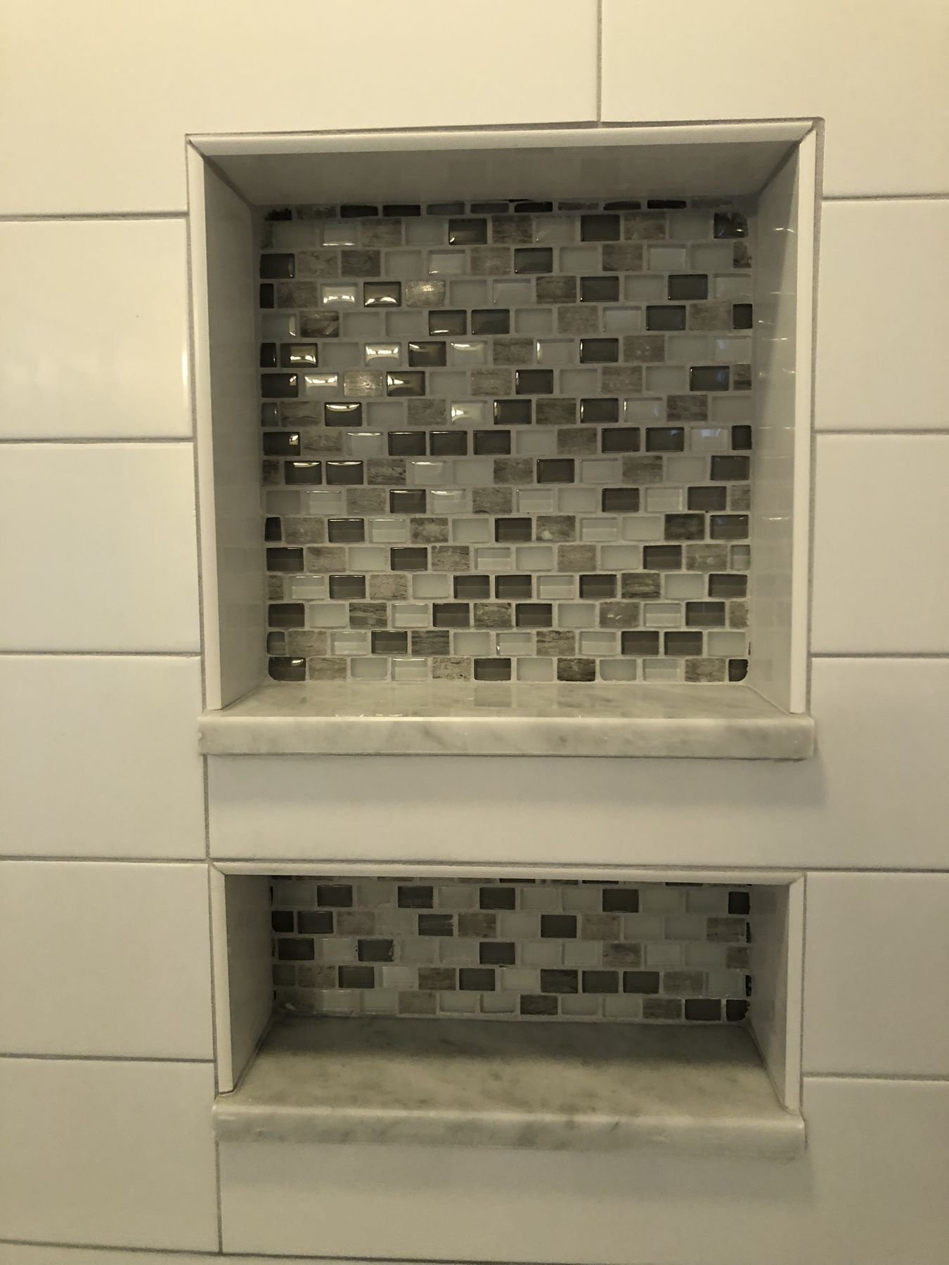 Tiled shower niches with mosaic
