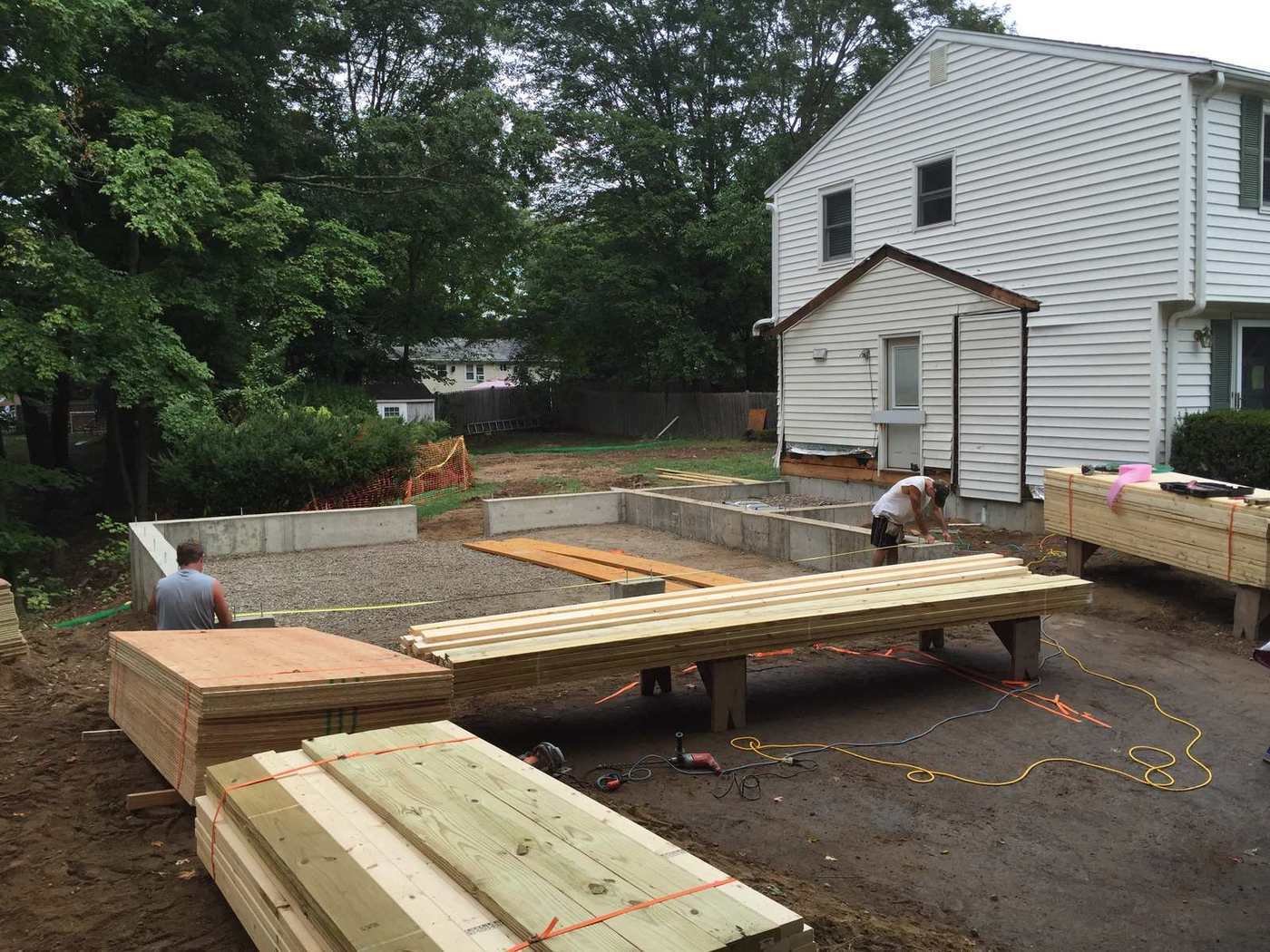 Poured foundation with beams staged on site