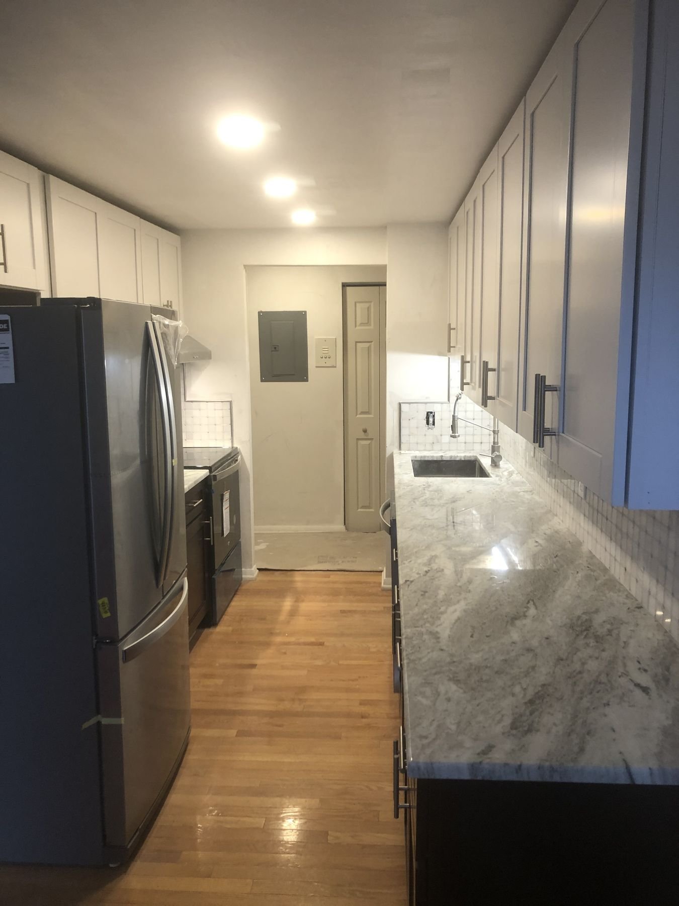 Galley kitchen with navy cabinets