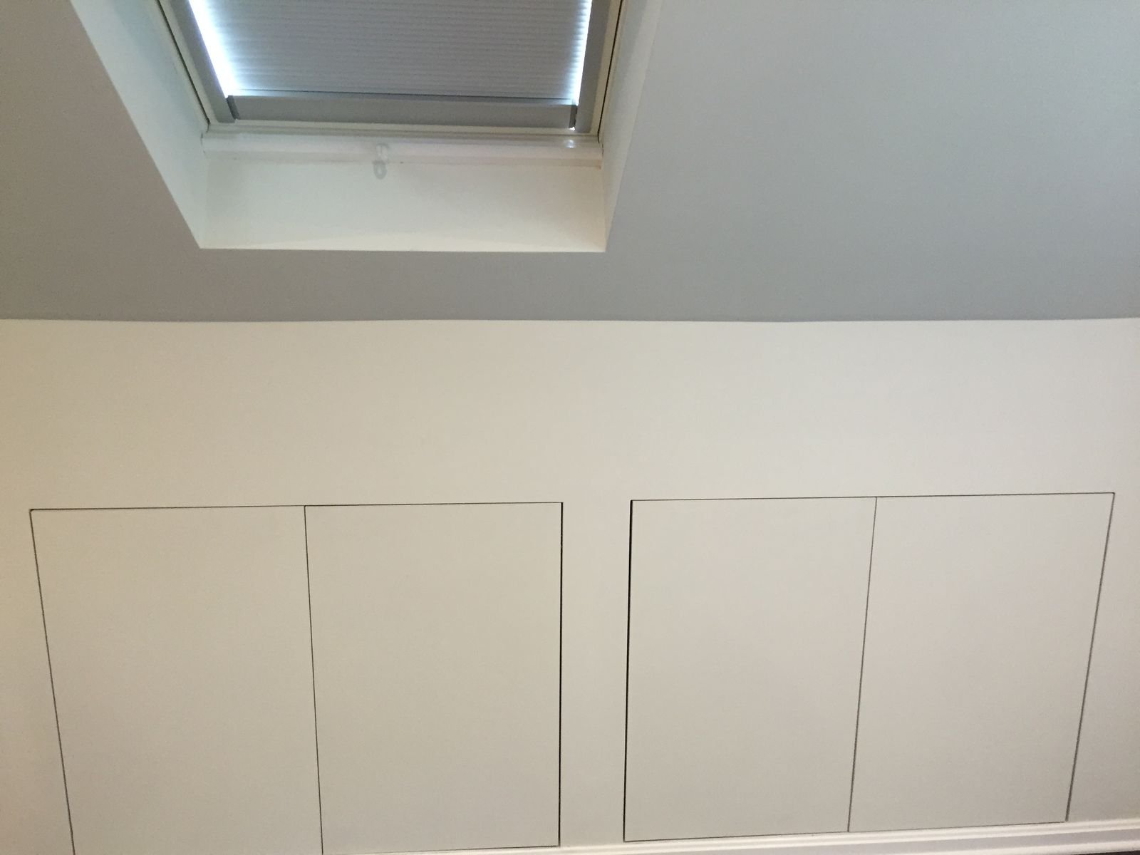 Knee-wall storage doors under the roof slope